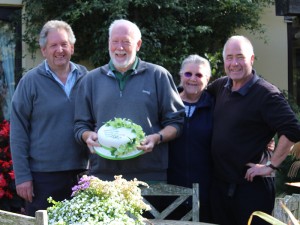 Winners Eve and John Evans being presented with the cake